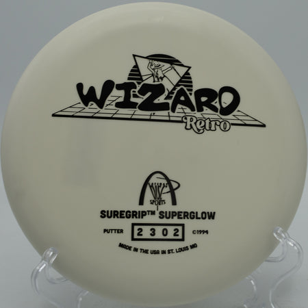 Retro stamp Suregrip Superglow Wizard glowing during a night round at Oregon Park Disc Golf Course in Marietta, GA