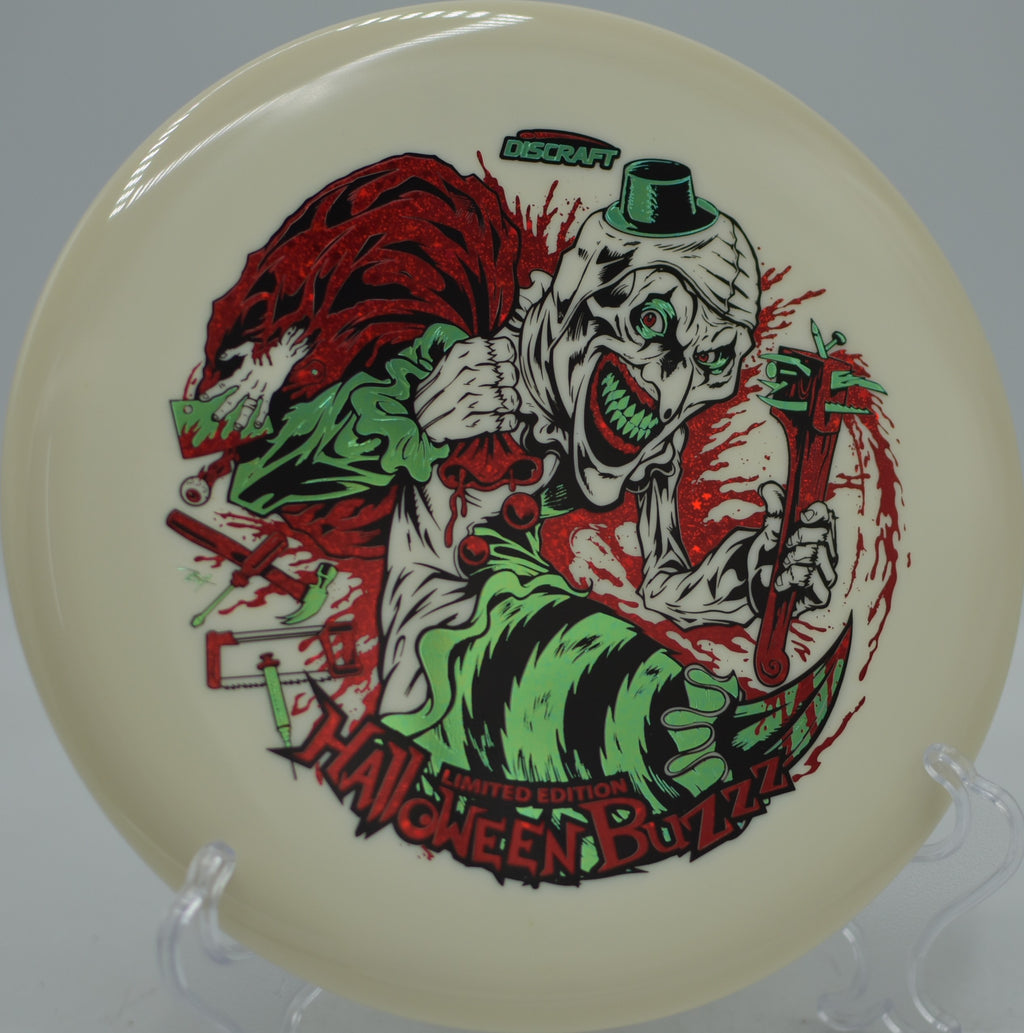 Discraft Halloween Glo Triple Stamp Buzzz 2025 glowing midrange at Pyramids Disc Golf Course in Leicester, Massachusetts.