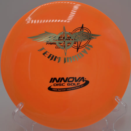 Player driving the Star Teebird Team Stamp on a precise hyzer line at Harmon Hills Disc Golf Course in Fall Branch, Tennessee.

