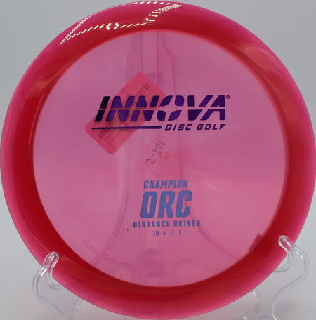 Champion Orc gliding through a tree gap with controlled fade at Idlewild Disc Golf Course in Burlington, KY