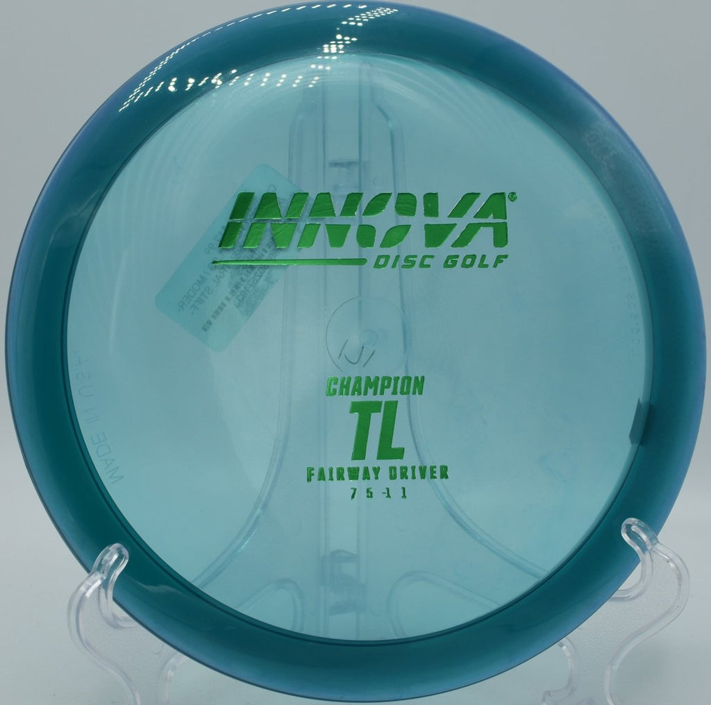 Innova Champion TL driver driving a controlled placement shot through tight trees at Hidden Lake Disc Golf Course in Martinez, Georgia
