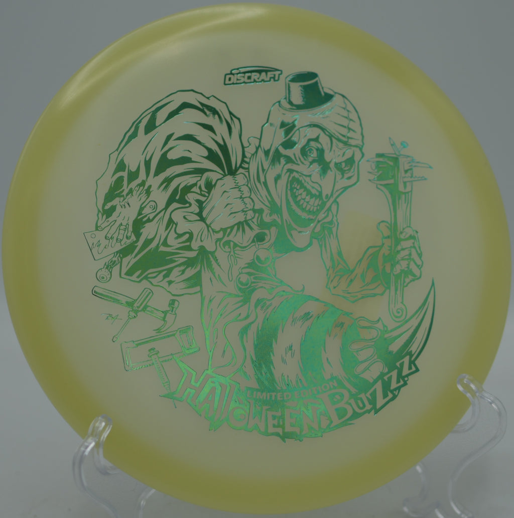 Discraft LE 2025 Halloween Mega Glo Single Stamped Buzzz flat release under glow lights at Golden Eagle Disc Golf Course in Branson, Missouri.