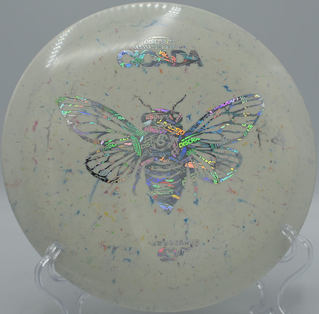 ESP Jawbreaker Cicada flying flat through tight trees at Sabattus Disc Golf Course in Sabattus, Maine, made for dead-straight midrange lines.

