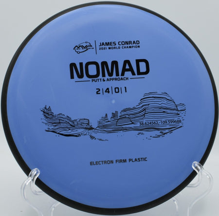Electron Firm Nomad putter resting under basket chains after a confident putt at Rocky Ford Disc Golf Course in Columbia, Missouri