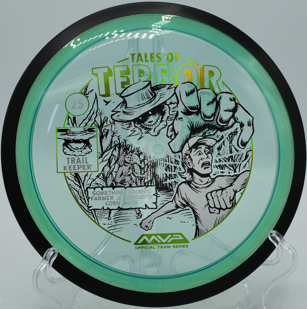 Halloween-stamped Trail disc from MVP sailing down a narrow lane at Ewing Park Disc Golf Course in Des Moines, Iowa.