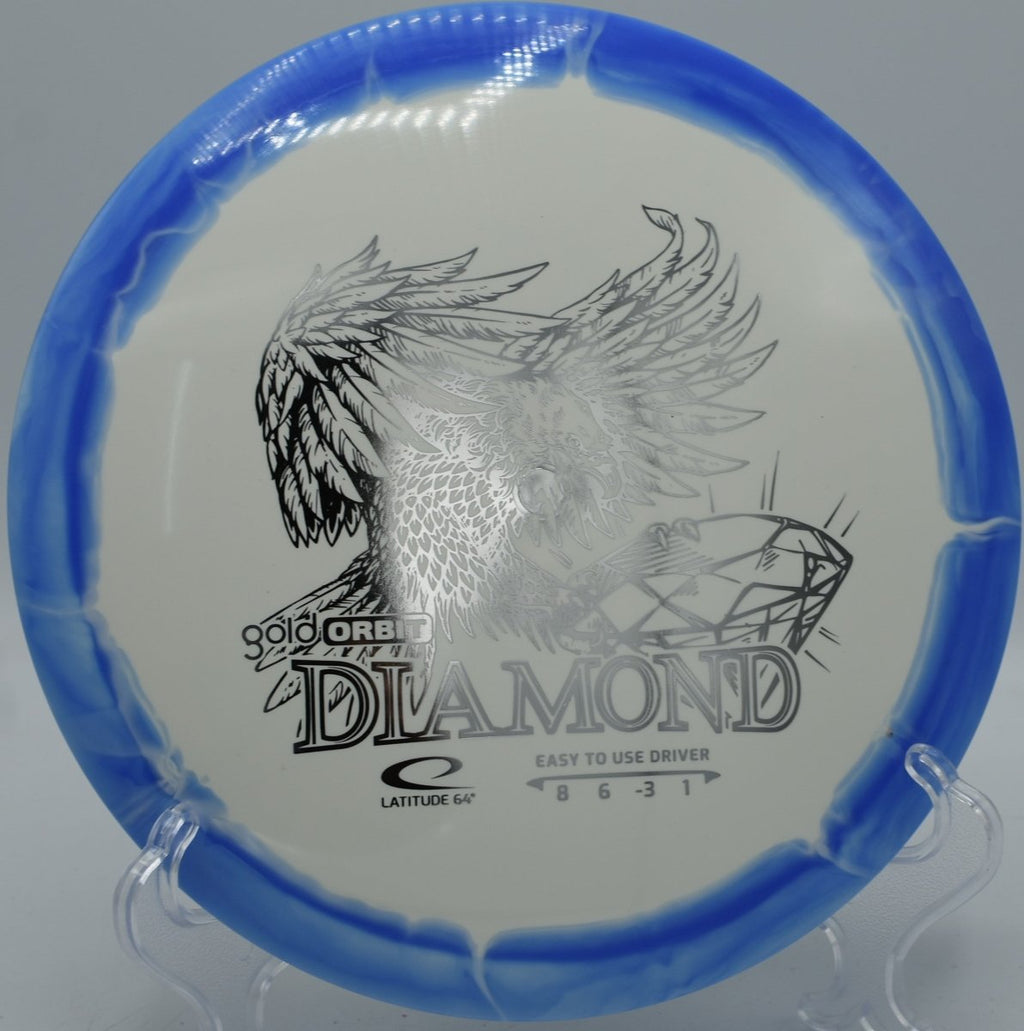 Gold Orbit Diamond fairway driver displayed beside tee sign at Trophy Club Disc Golf Course in Trophy Club, Texas