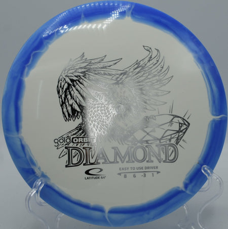 Gold Orbit Diamond fairway driver displayed beside tee sign at Trophy Club Disc Golf Course in Trophy Club, Texas