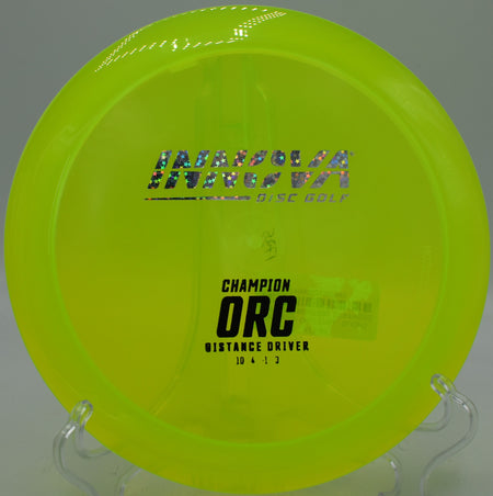 Side profile of a Champion Orc mid-flight on a sweeping hyzer at SeaTac Disc Golf Course in SeaTac, WA