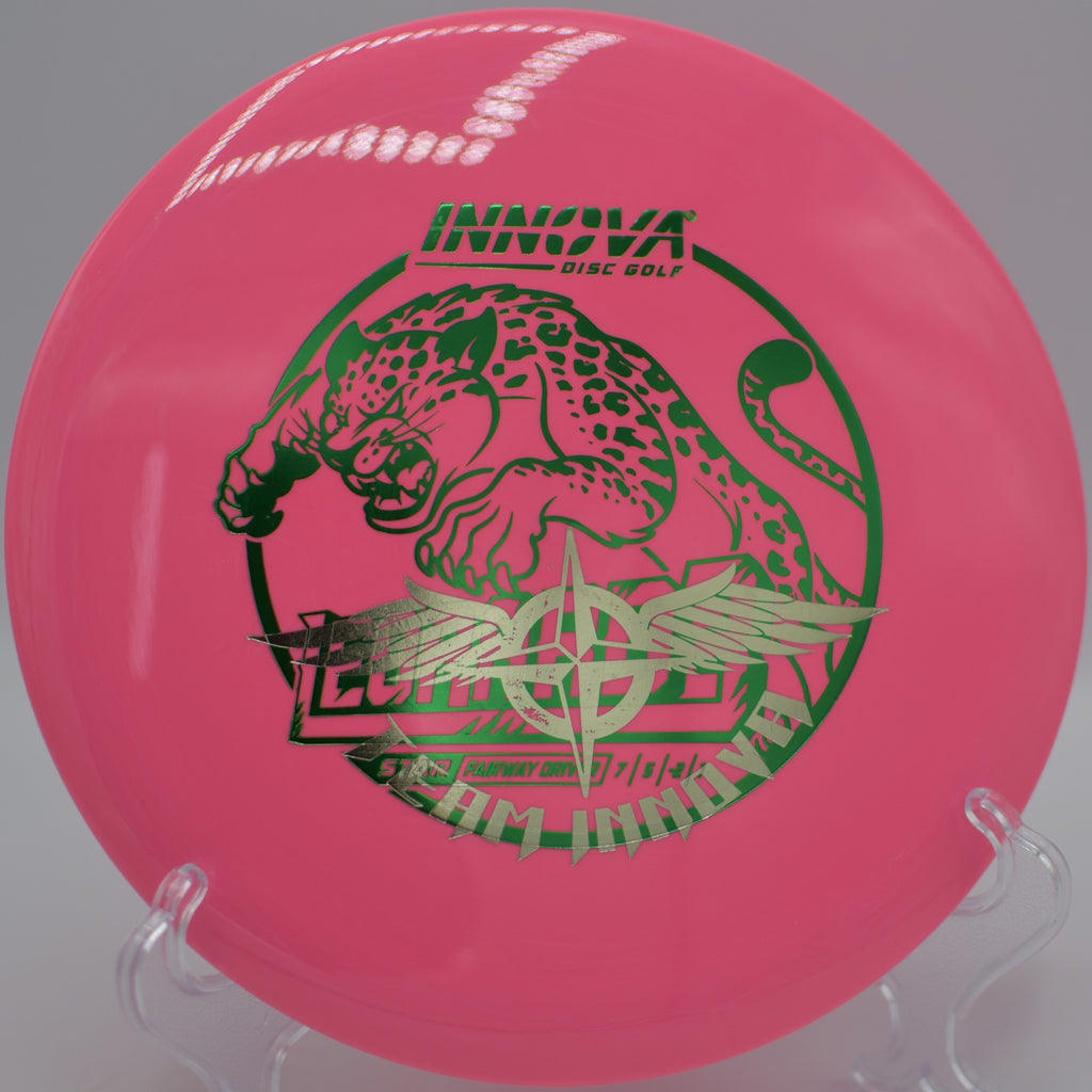 Player throwing a Star Leopard3 Team Stamp through a wooded fairway gap at Nevin Park Disc Golf Course in Charlotte, North Carolina.