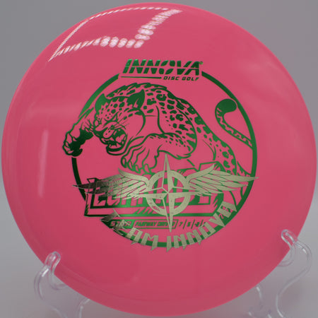 Player throwing a Star Leopard3 Team Stamp through a wooded fairway gap at Nevin Park Disc Golf Course in Charlotte, North Carolina.