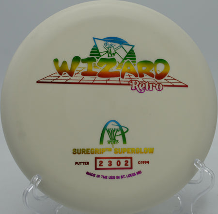 Retro-stamped Superglow Wizard glowing under UV light at Lakewood King County Disc Golf Course in WA