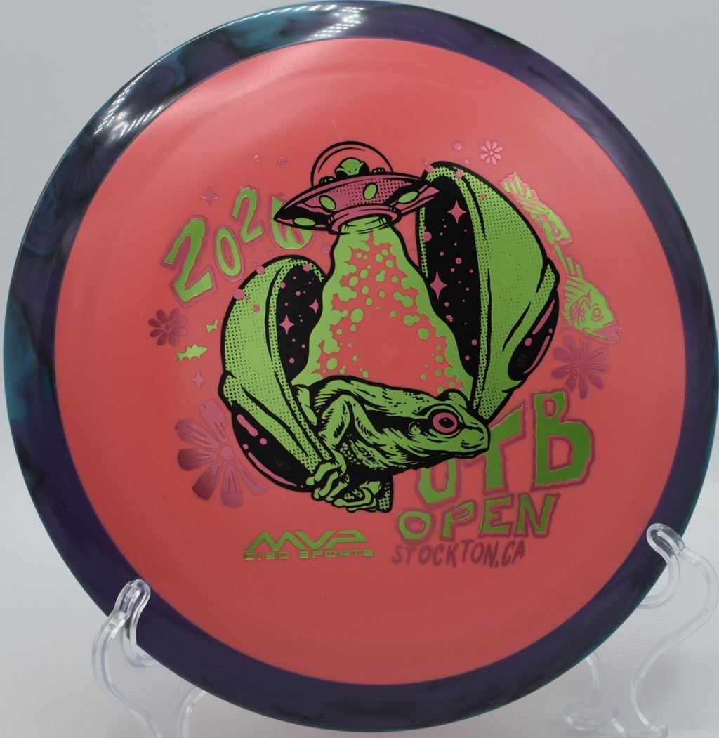 Axiom Fission Delirium OTB Open distance driver displayed on wooded tee pad at Morley Field Disc Golf Course in San Diego, California