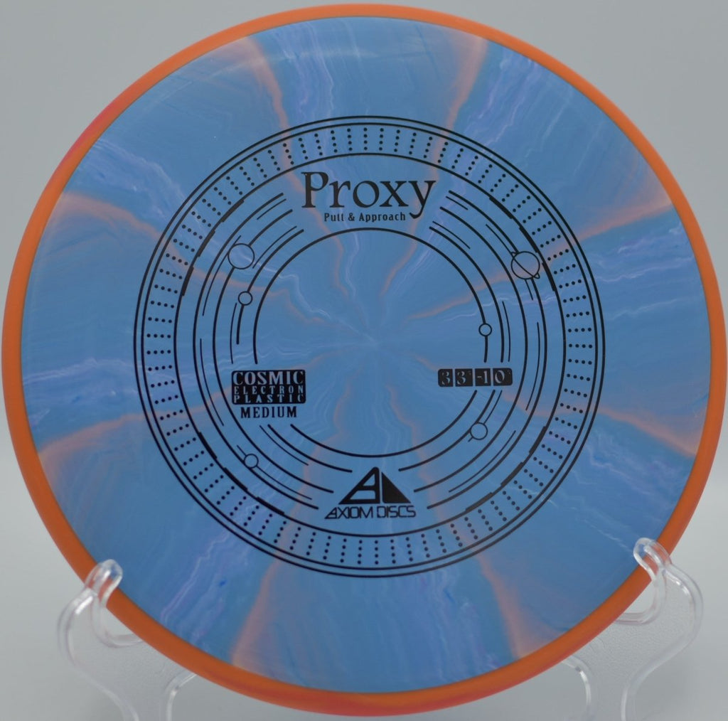 Axiom Cosmic Electron Proxy putter delivering point-and-shoot accuracy on a wooded green at Harmony Bends Disc Golf Course in Columbia, Missouri