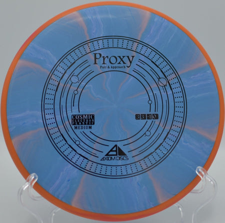 Axiom Cosmic Electron Proxy putter delivering point-and-shoot accuracy on a wooded green at Harmony Bends Disc Golf Course in Columbia, Missouri