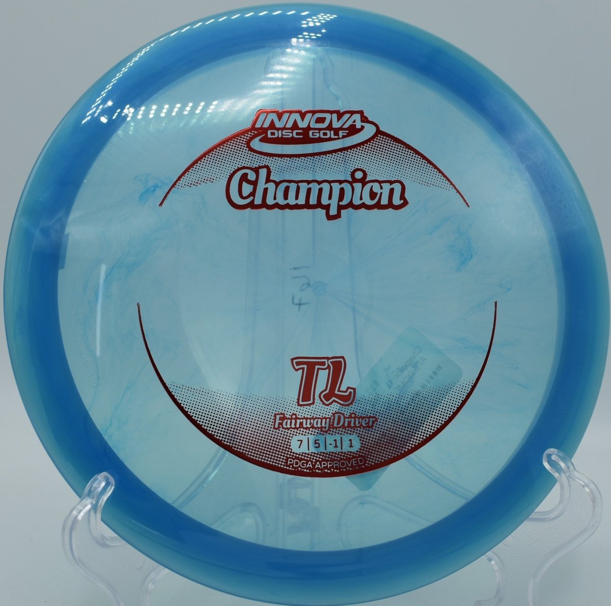 Innova Champion TL driver shaping a turnover fairway line through woods at Cliff Stephens Park Disc Golf Course in Clearwater, Florida
