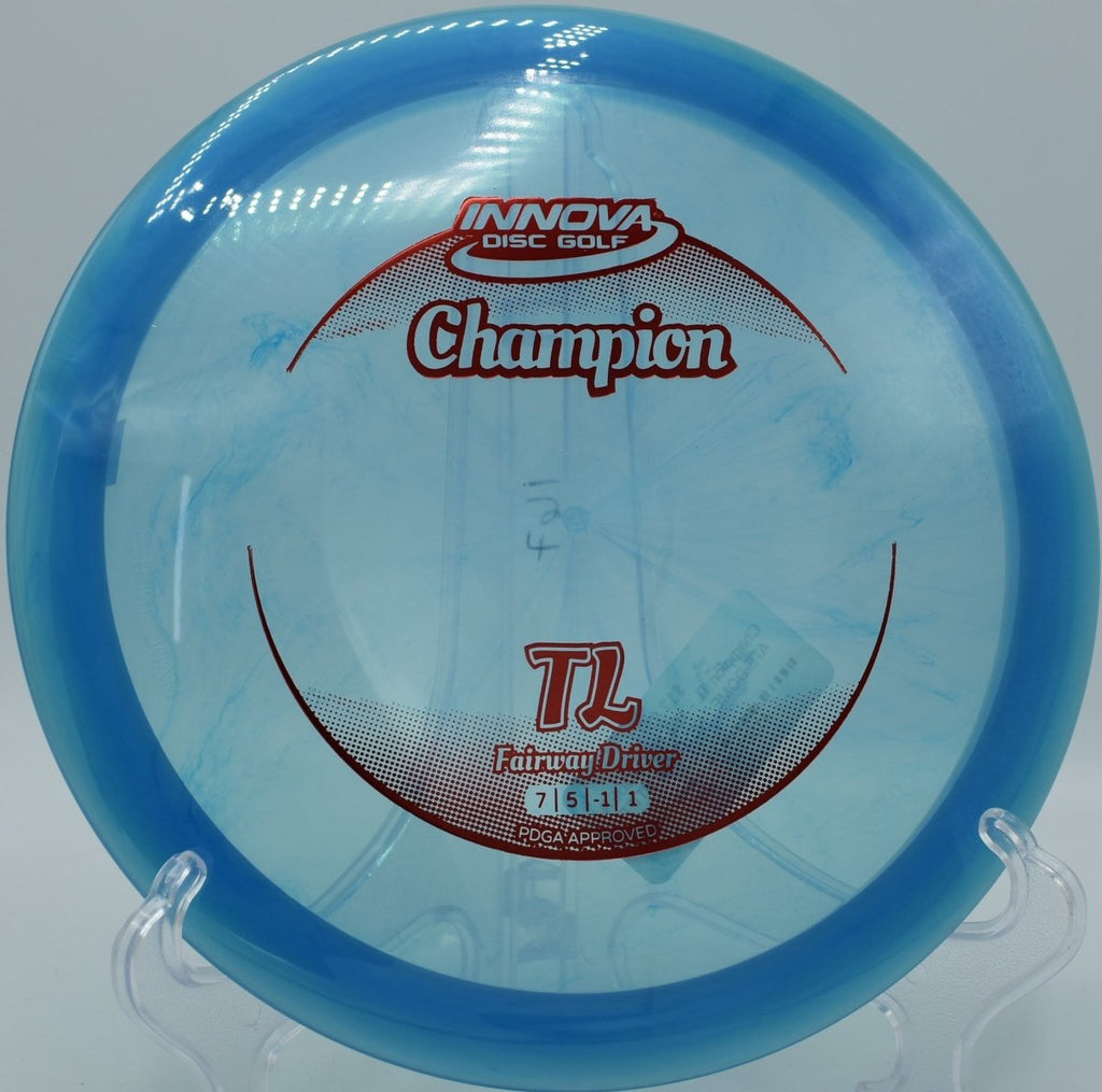 Innova Champion TL driver shaping a turnover fairway line through woods at Cliff Stephens Park Disc Golf Course in Clearwater, Florida