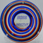 Colorful I-Dye Boss disc launched forehand off the tee pad at Harmony Bends Disc Golf Course in Columbia, Missouri