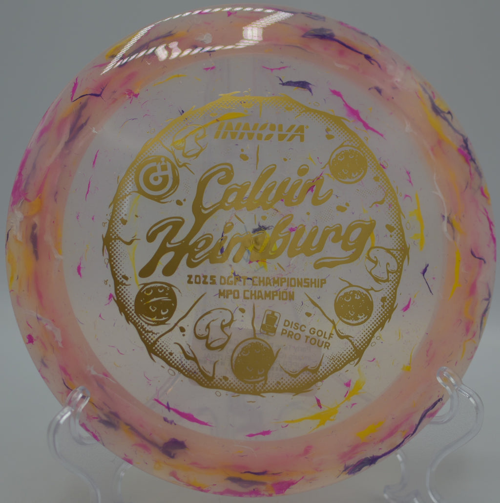 Player driving the Calvin Heimburg Commemorative Destroyer through tropical vegetation at Lake Olmstead Park Disc Golf Course in Fort Myers, Florida.