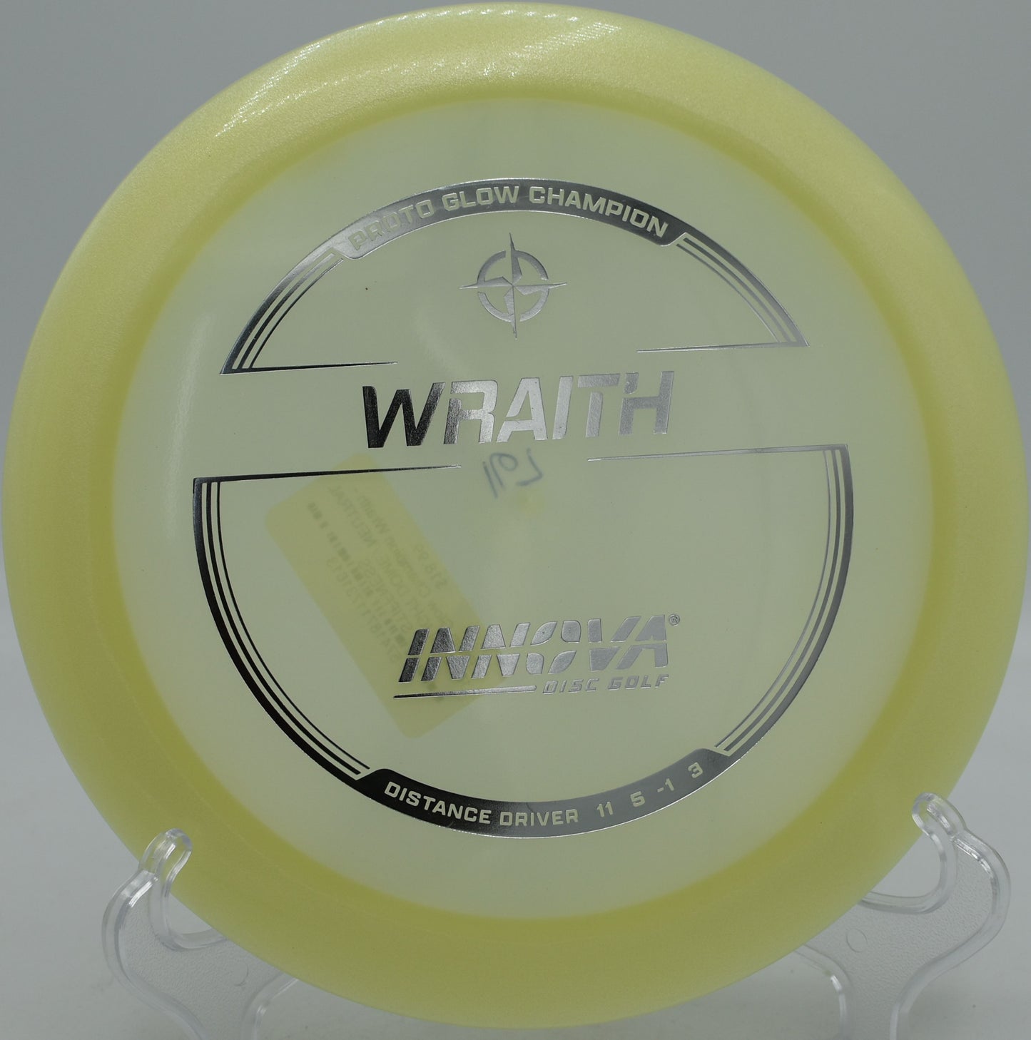 Disc golfer launching a Proto Glow Champion Wraith under stadium lights at Lake Marshall in Montross, VA