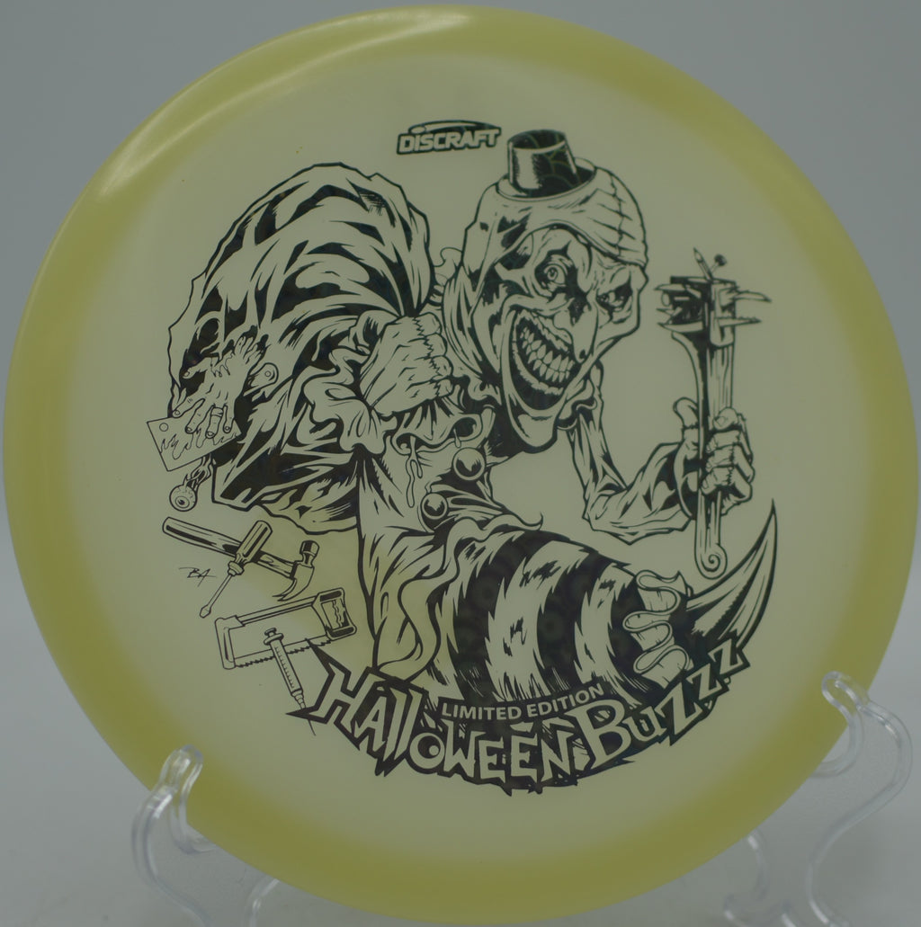 Discraft 2025 Halloween Mega Glo Buzzz single stamp cutting a tunnel shot at Indian Hills Disc Golf Course in Huntsville, Alabama.