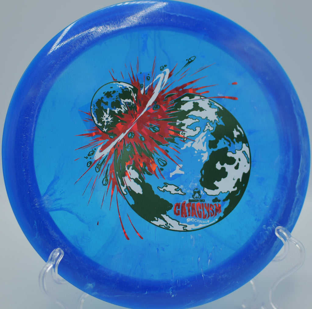 Shockwave Cataclysm launching down the fairway at Cedar Hill DGC in Cookeville, TN, holding a slight turn before snapping back into a hard finish.