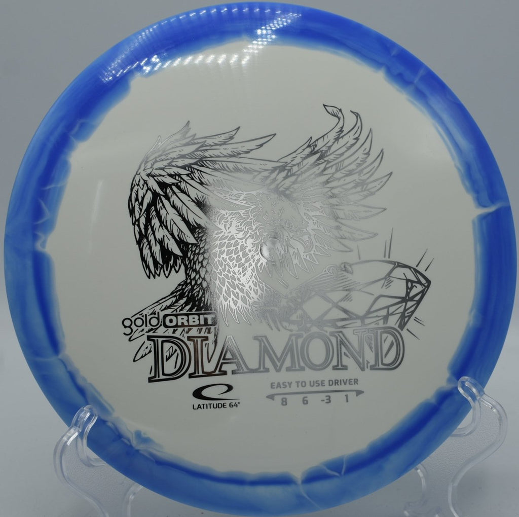 Gold Orbit Diamond understable driver resting on rocky fairway at Iron Hill Disc Golf Course in Newark, Delaware