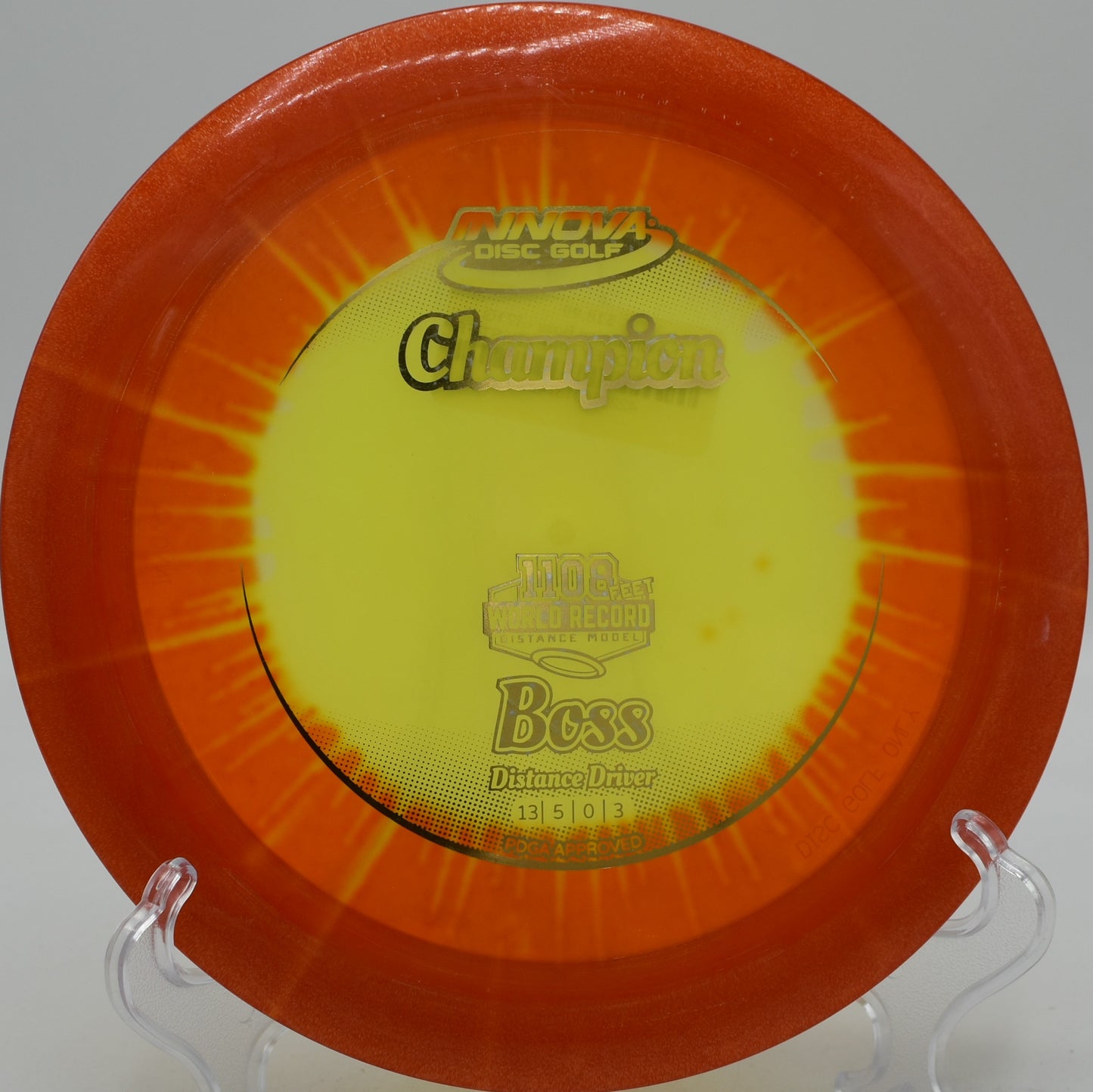 I-Dye Champion plastic Boss flying over water on a power hyzer at Blue Ribbon Pines in East Bethel, Minnesota