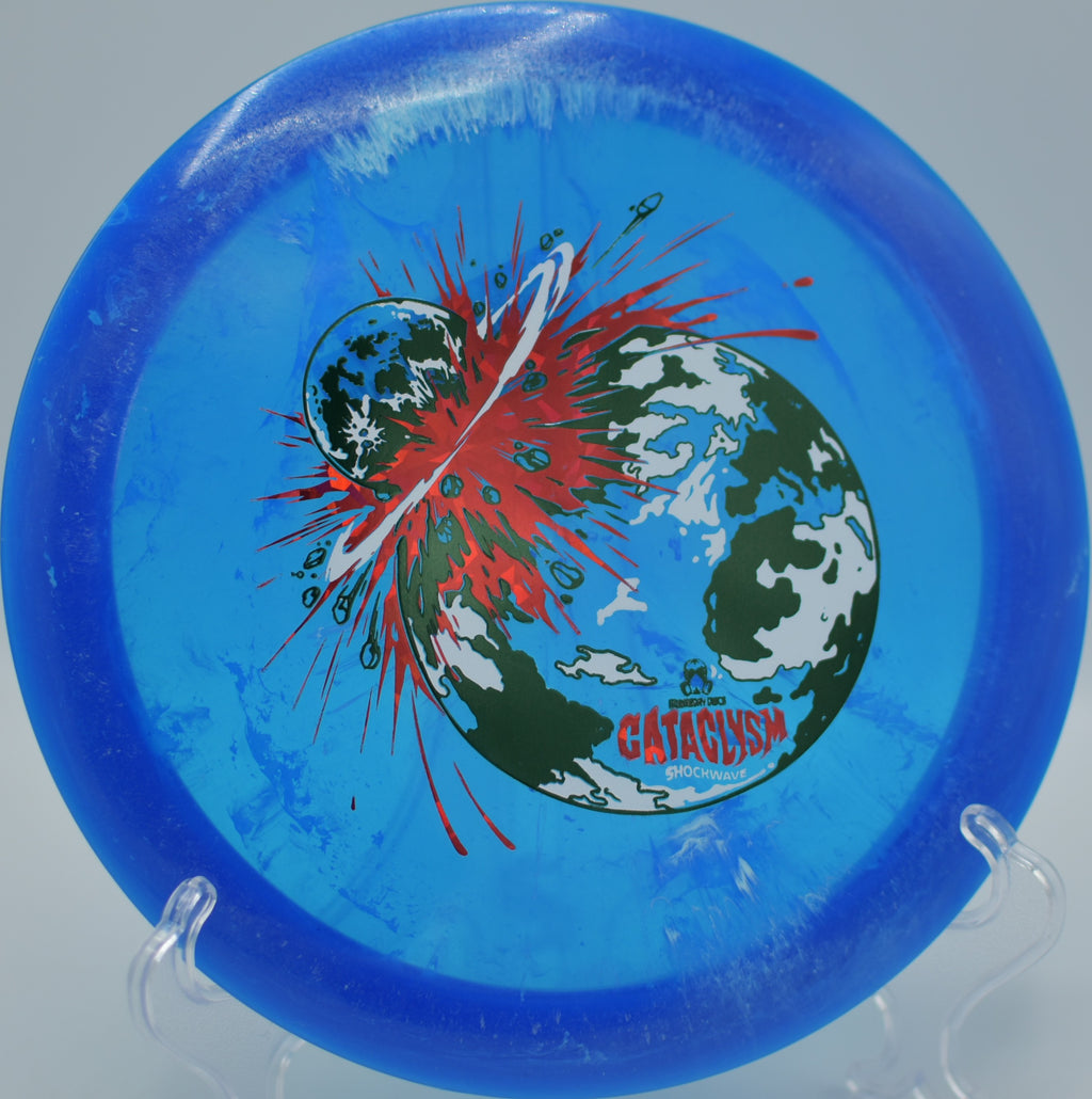 Doomsday Shockwave Cataclysm smashing a downhill bomb at Prairie Pass DGC in Round Rock, TX, gliding deep with a forceful, overstable fade.