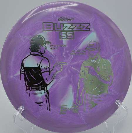 Ezra Aderhold & Robinson ESP Buzzz SS gliding between pines at Hornets Nest Disc Golf Course in Charlotte, North Carolina.