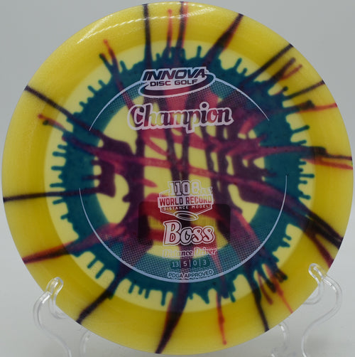 Innova I-Dye Boss mid-flight during a headwind crush at Bucksnort Disc Golf Course in Pine, Colorado