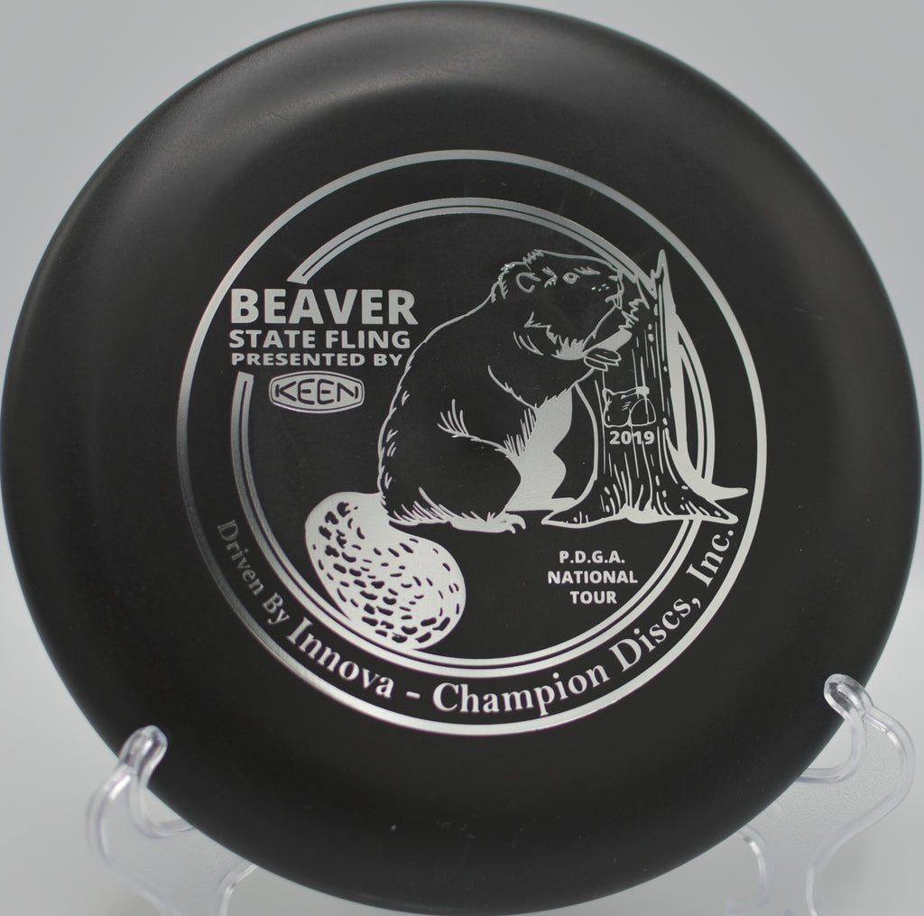 KC Pro Aviar (Beaver State Fling) resting beside the basket at Pier Park Disc Golf Course in Portland, Oregon.