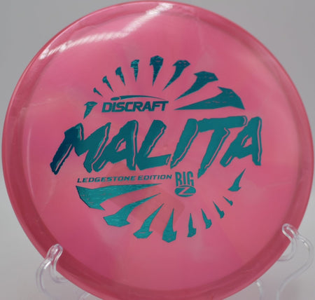 2026 Ledgestone Big Z Swirl Malita midrange executing a smooth turnover at Rollin Ridge Disc Golf Course in Reedsville, Wisconsin