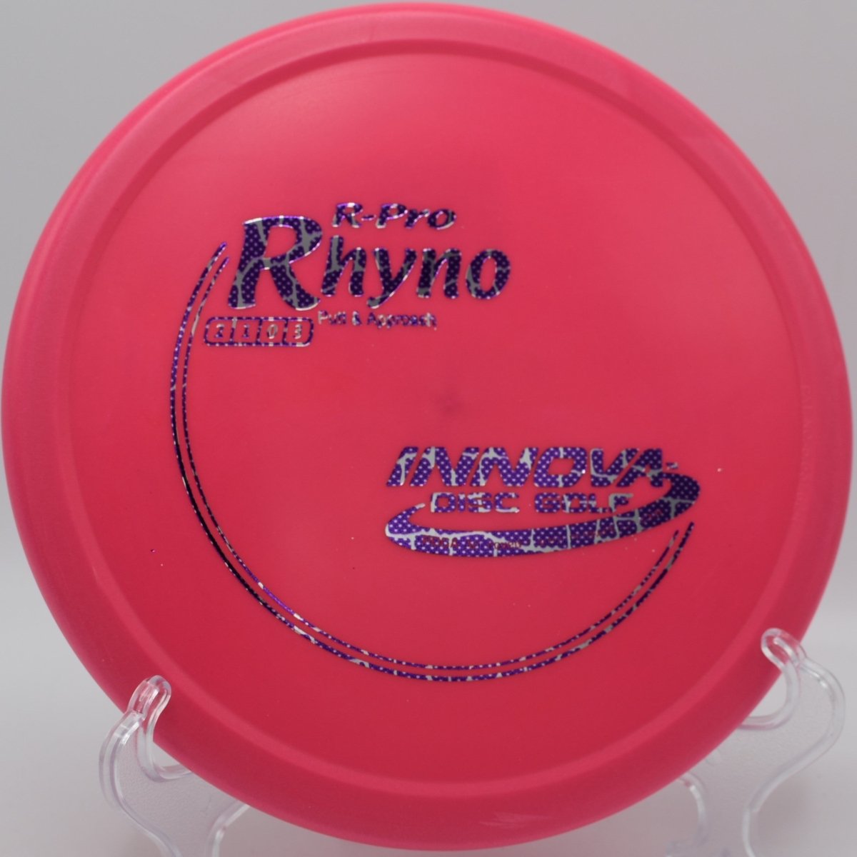 Innova R-Pro Rhyno putter resting near chains after a controlled hyzer upshot at Rock Ridge Disc Golf Course in Pittsboro, North Carolina