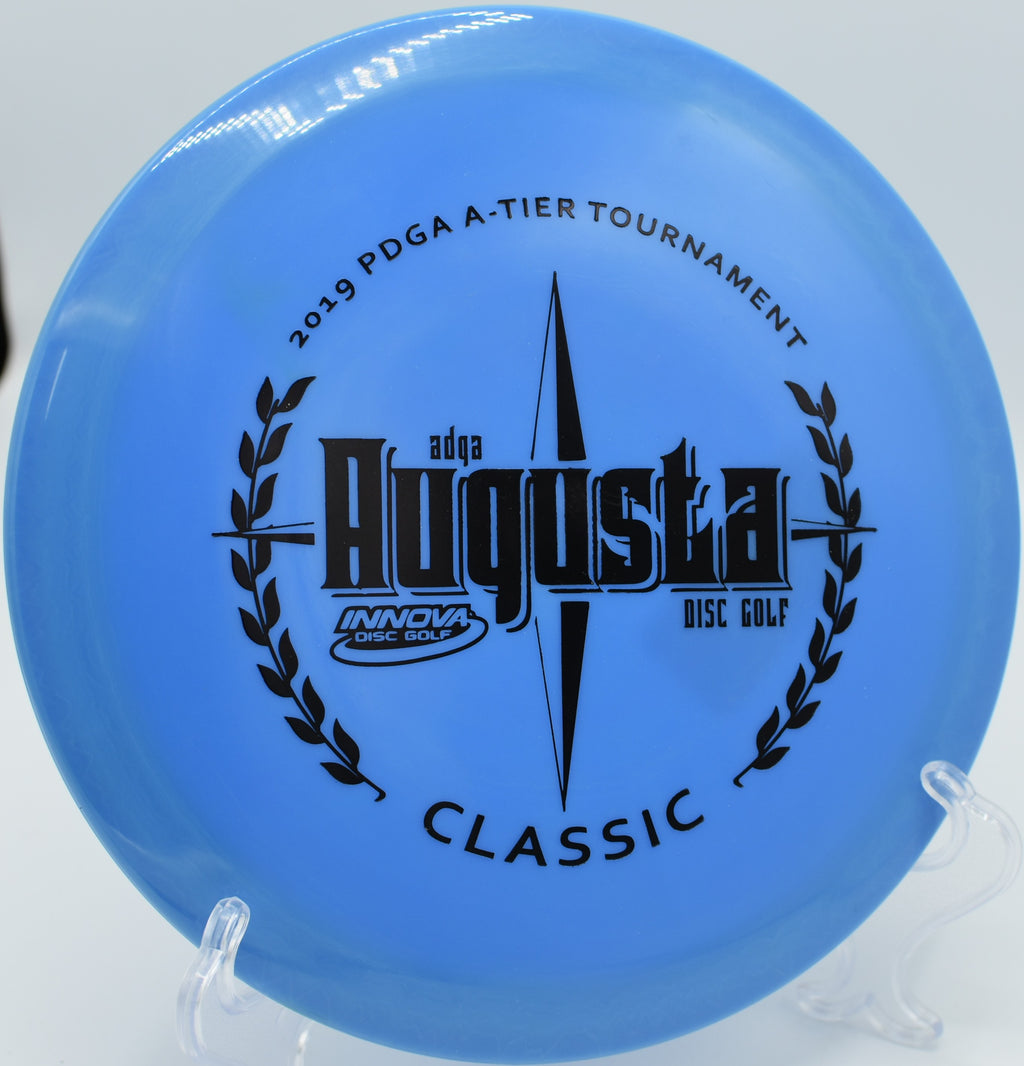 A disc golfer shaping a precision backhand shot with a Star Teebird at Wildcat Bluff Disc Golf Course in Urbana, Iowa.