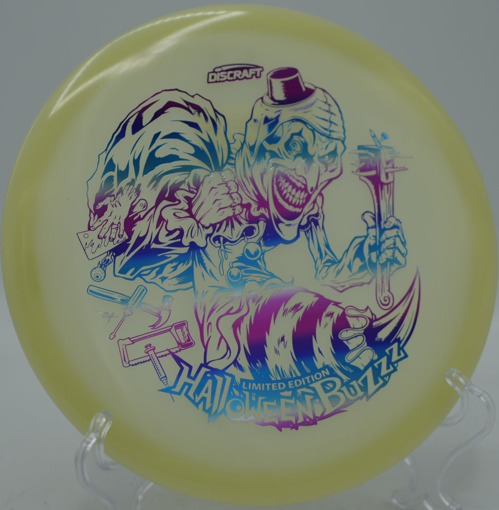 Discraft 2025 LE Halloween Mega Glo Single Stamped Buzzz glowing bright at Bear Mountain Disc Golf Course in New Mexico.