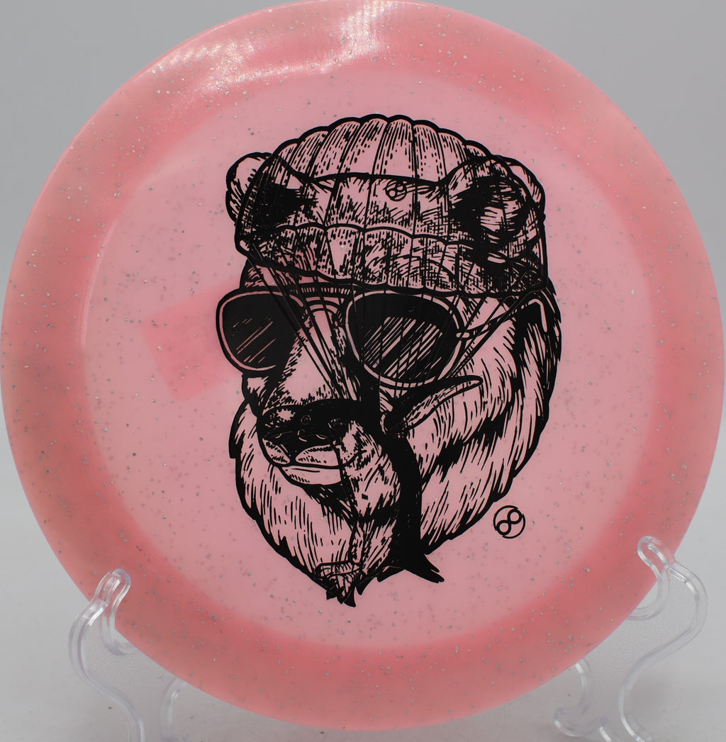 Metal Flake Glow C-Blend X-Out Pharaoh Infinite Discs distance driver spiking down on a hyzer at Northwood Black Disc Golf Course in Morton, Illinois.