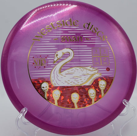 Westside Discs Swan putter positioned for a straddle putt at Snyder Park Disc Golf Course in Fort Lauderdale, Florida