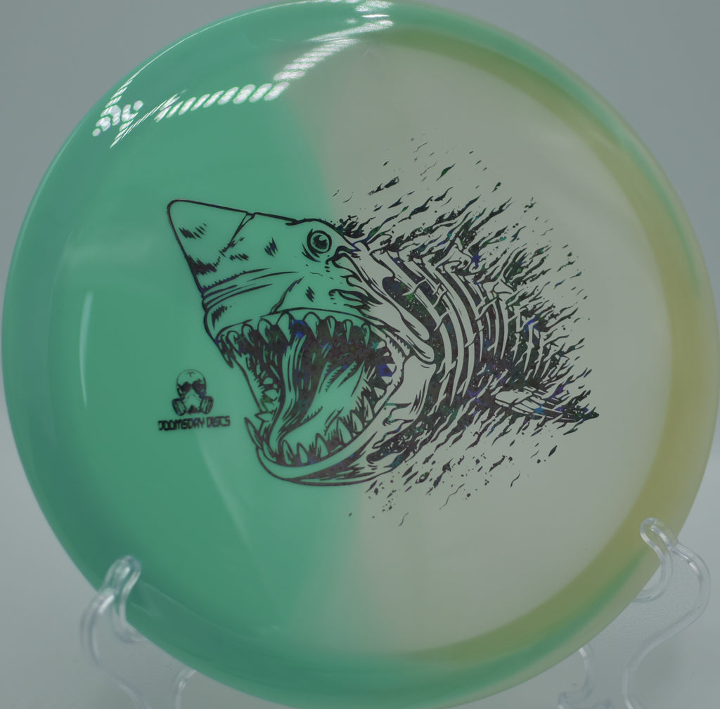 Doomsday Discs Retina Glow Chemtrail on the tee at Two Rivers DGC in Fargo, ND, emphasizing its glide-first understable flight.