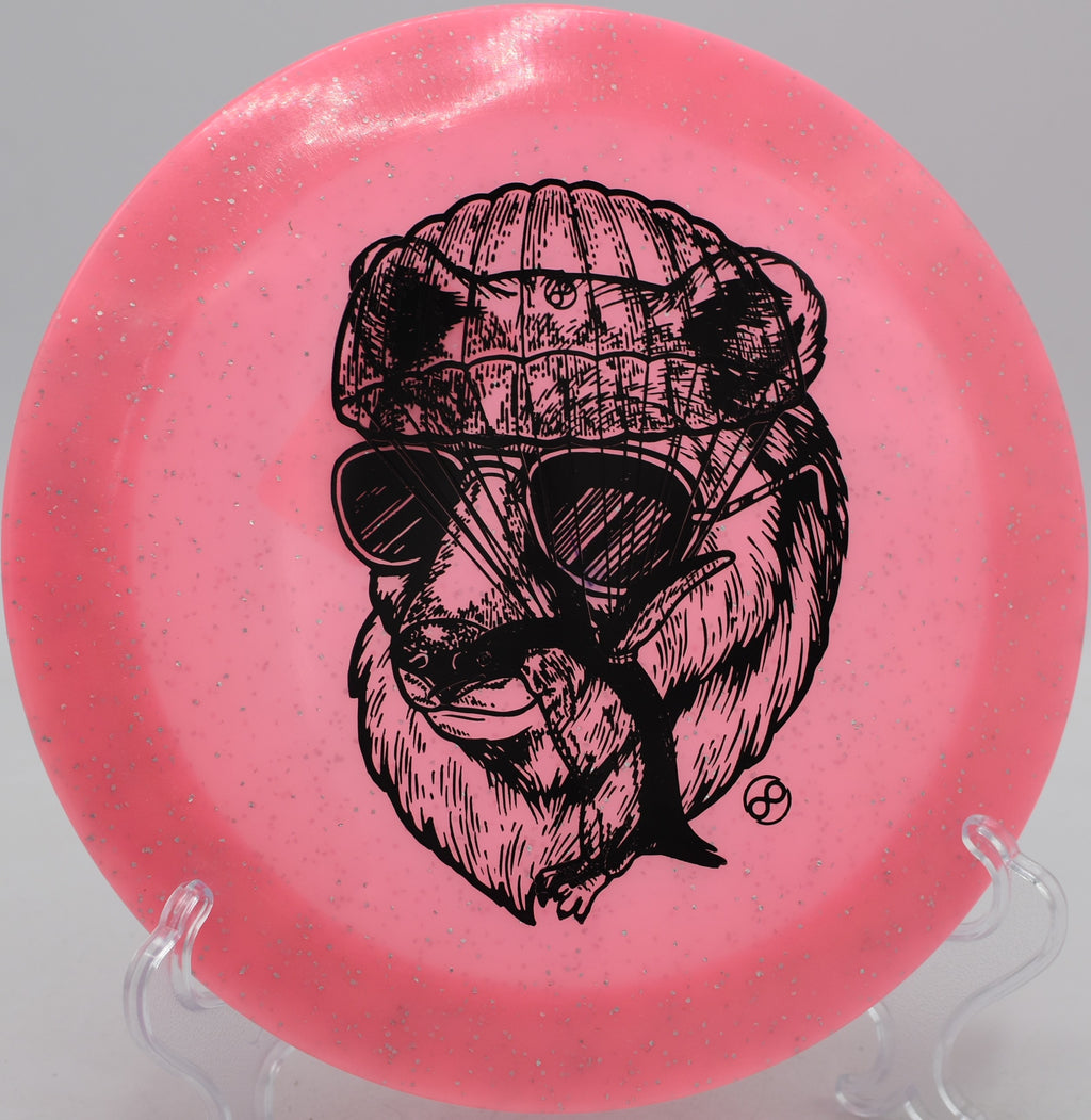 Infinite Discs X-Out Pharaoh Metal Flake Glow C-Blend driver glowing bright in night golf at Winthrop Gold Disc Golf Course in Rock Hill, South Carolina.