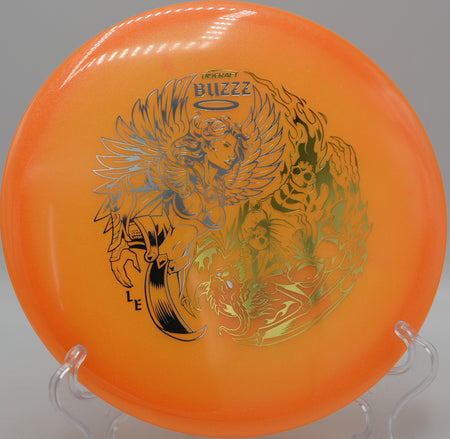 Colorshift Z Glo Buzzz midrange flying straight through a wooded tunnel at Idlewild Disc Golf Course in Burlington, Kentucky, perfect for neutral lines with late fade.

