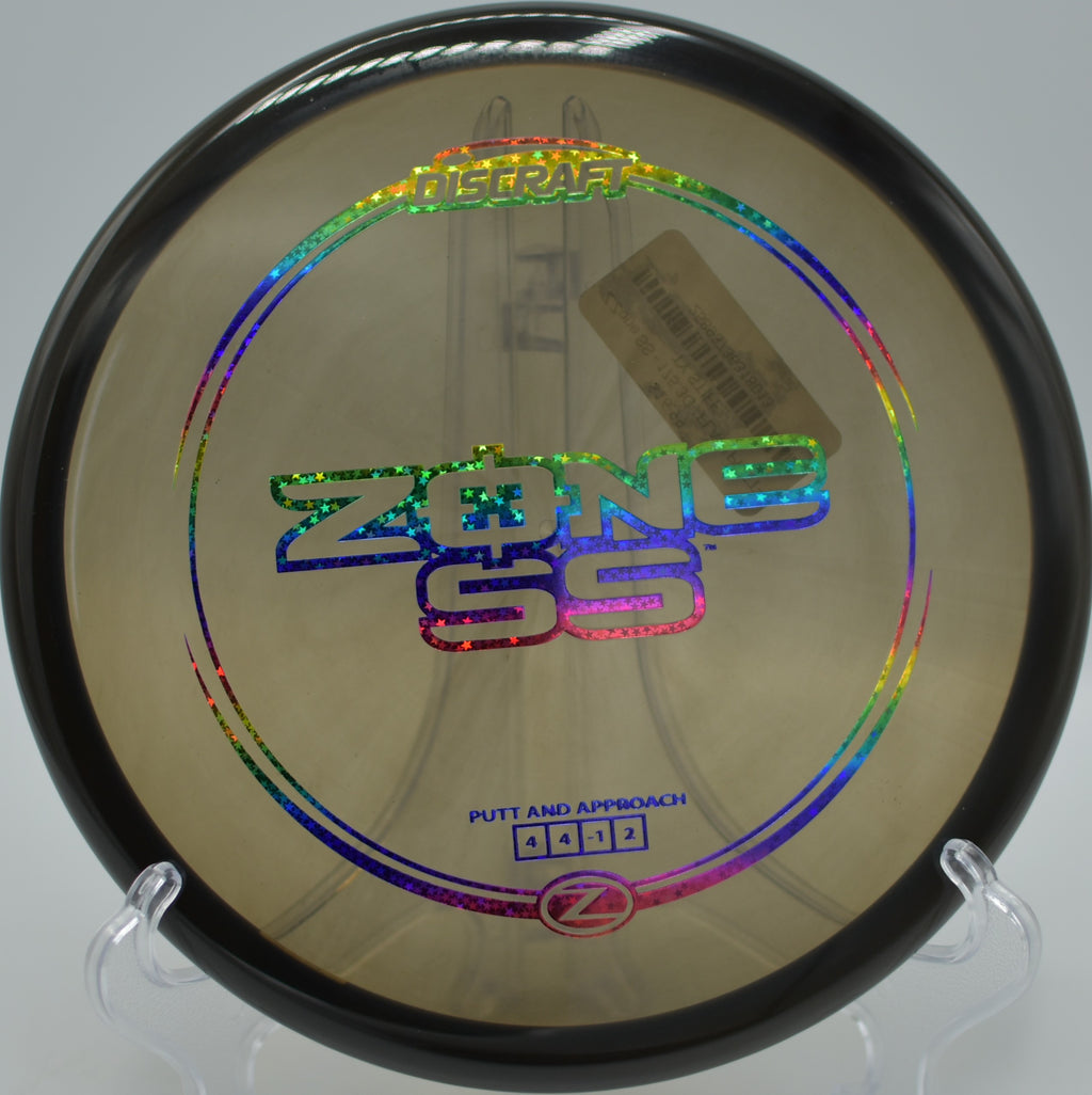 Discraft Z Zone SS resting near the cage after a clean upshot at CSU Monterey Bay Disc Golf Course in Seaside, California.