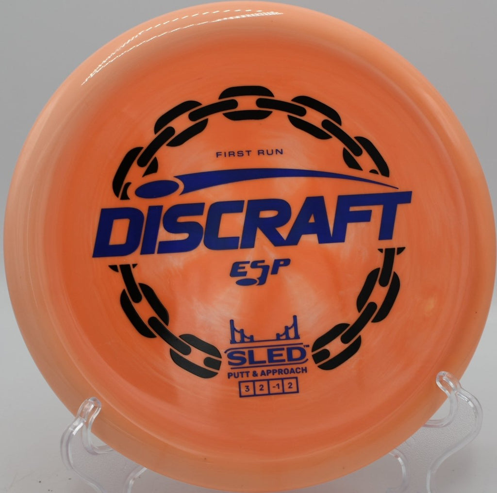 First Run ESP Sled technical approach disc in wooded gap at Flip City Disc Golf Park in Shelby, Michigan