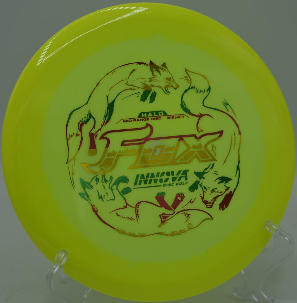 Innova Halo Star Fox in flight with two-tone rim spinning through sunlight at Maple Hill Disc Golf Course in Leicester, Massachusetts.