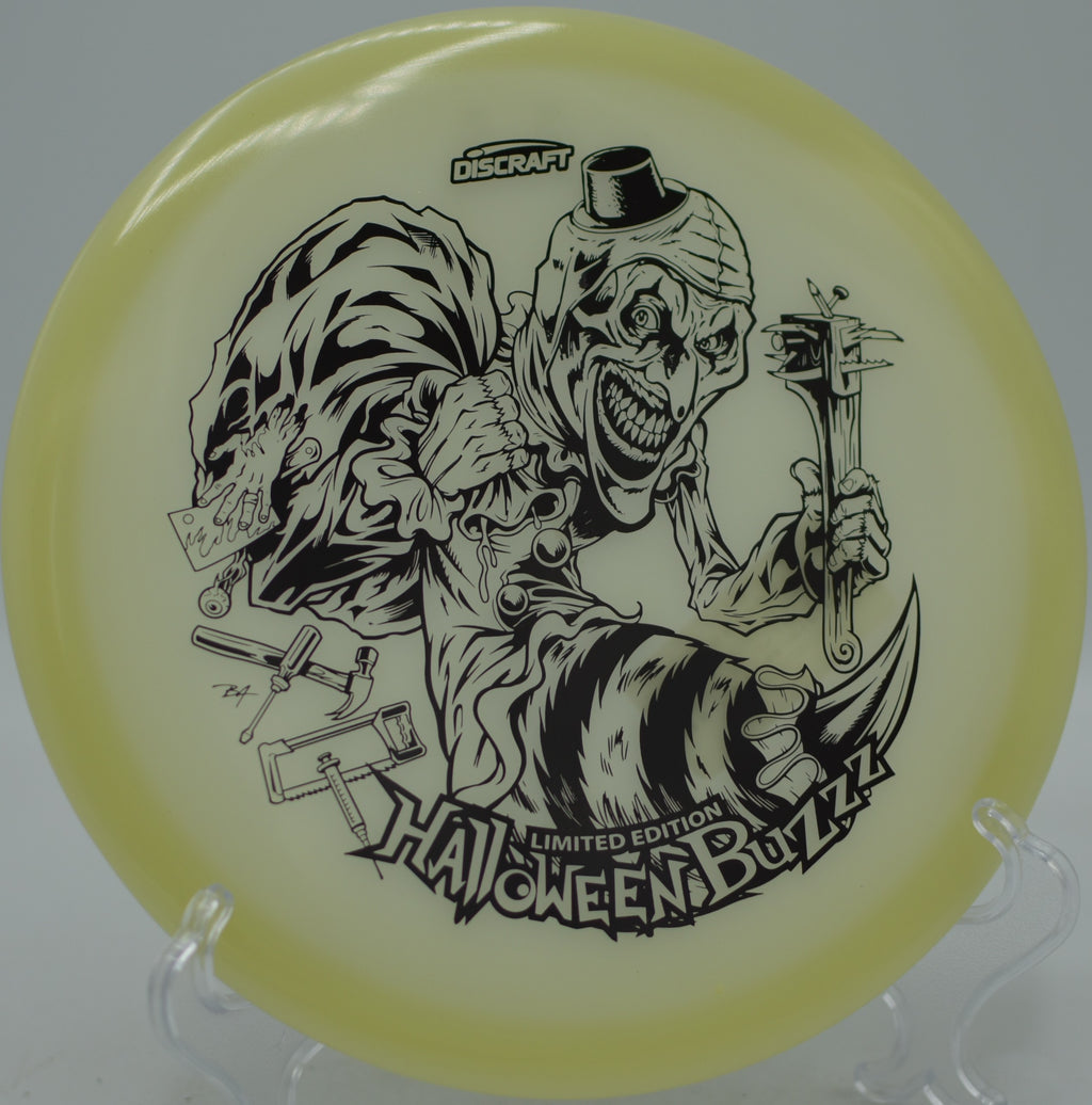 2025 LE Halloween Mega Glo Single Stamped Buzzz carving a wooded approach at Creekside West Disc Golf Course in Salt Lake City, Utah.