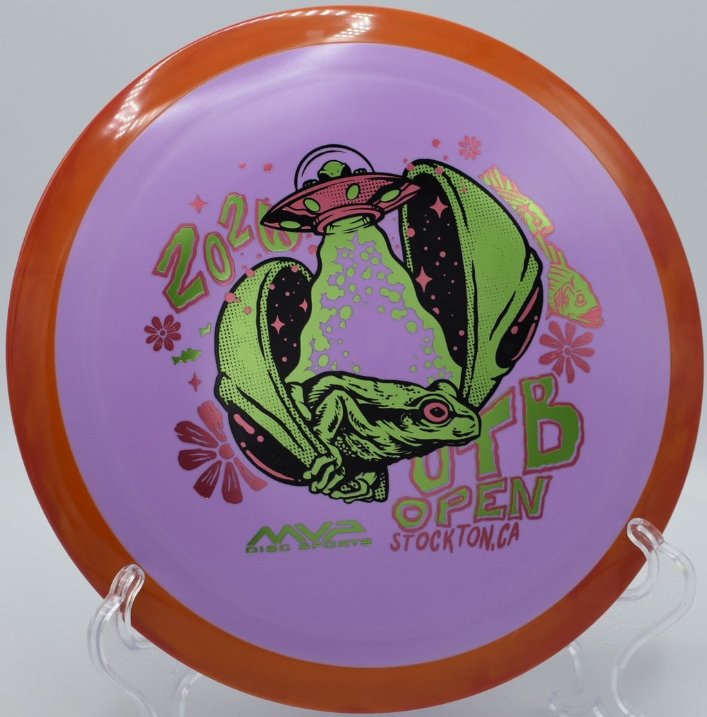 Axiom Fission Delirium OTB Open driver placed beside basket at Eagles Crossing Disc Golf Course in Hawk Point, Missouri