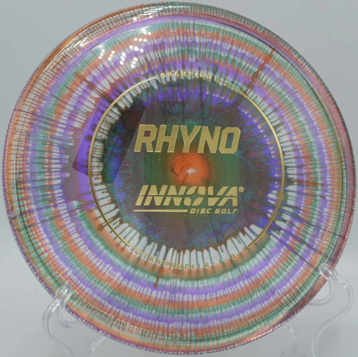 Innova I-Dye Champion Rhyno putter resting near chains after a torque-resistant approach at Green Valley Park Disc Golf Course in Payson, Arizona
