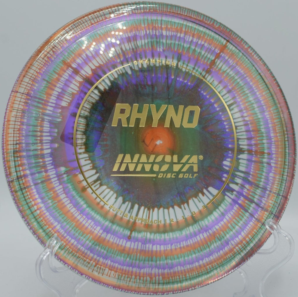 Innova I-Dye Champion Rhyno putter resting near chains after a torque-resistant approach at Green Valley Park Disc Golf Course in Payson, Arizona