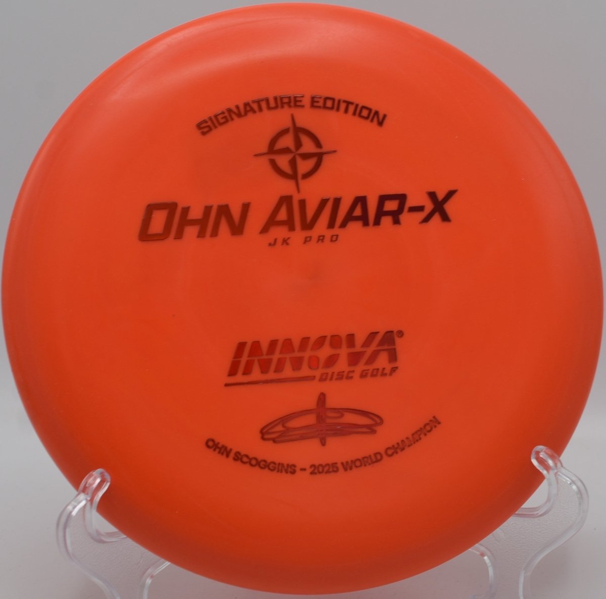 JK Aviar-X putter lying beside the basket pole after a straight approach shot at Rock Ridge Disc Golf Course in Pittsboro, North Carolina