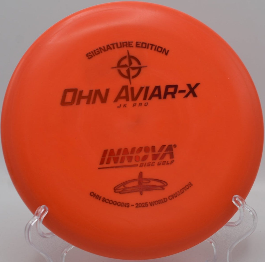 JK Aviar-X putter lying beside the basket pole after a straight approach shot at Rock Ridge Disc Golf Course in Pittsboro, North Carolina