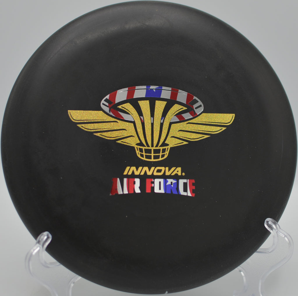 Air Force DX Big Bead Aviar (Penned) gliding over red rock terrain at Southern Utah University Disc Golf Course in Cedar City, Utah.